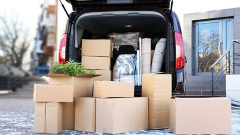 Trunk of a car loaded with moving boxes.