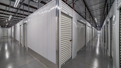Indoors Storage with White Metal Walls and White Garage like Doors.