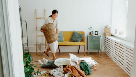 Woman emptying her laundry basket.