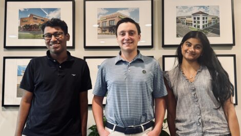 3 interns standing together in an office