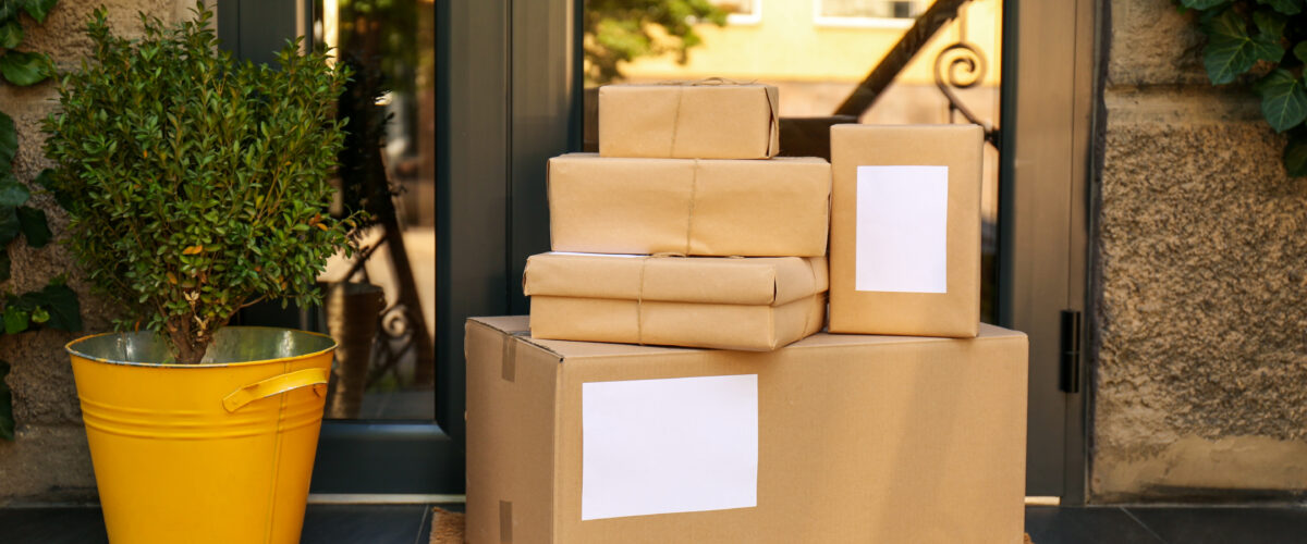 Delivered parcels on door mat near entrance of house