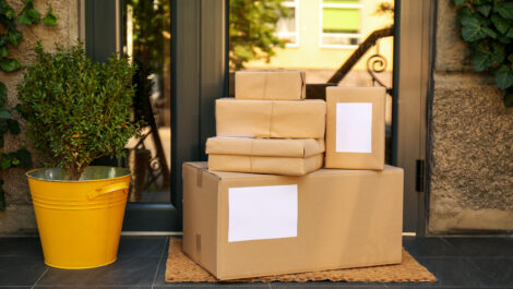 Delivered parcels on door mat near entrance of house